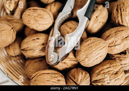 Nutcracker and walnuts in a large bowl Stock Photo