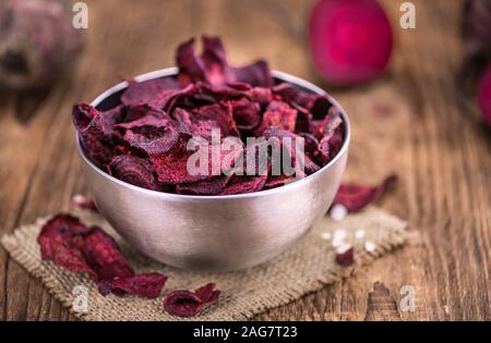 Some fresh Beetroot Chips on wooden background (selective focus; close-up shot) Stock Photo