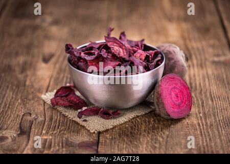 Some fresh Beetroot Chips on wooden background (selective focus; close-up shot) Stock Photo