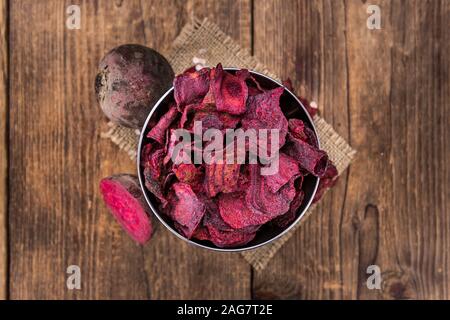 Wooden table with Beetroot Chips (detailed close-up shot; selective focus) Stock Photo