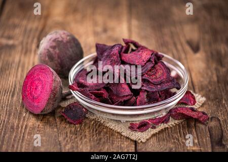 Wooden table with Beetroot Chips (detailed close-up shot; selective focus) Stock Photo