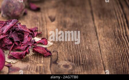 Wooden table with Beetroot Chips (detailed close-up shot; selective focus) Stock Photo