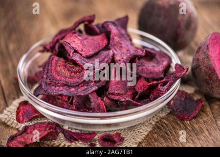 Some fresh Beetroot Chips on wooden background (selective focus; close-up shot) Stock Photo