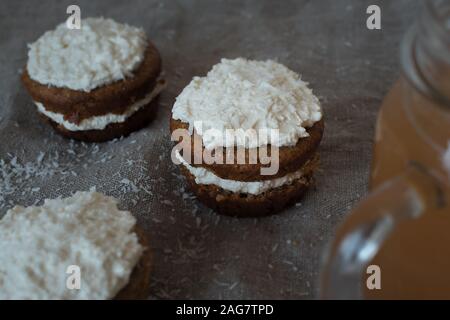 High angle shot of delicious buttercream coconut cupcakes on gray surface Stock Photo