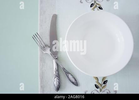 A white empty plate on a linen napkin Stock Photo