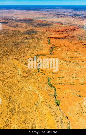 The green line is the valley that becomes Kings Canyon. This high aerial view shows the remote Northern Territory landscape the surrounds it. Stock Photo