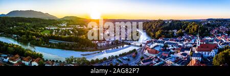 Aerial of old bavarian town Bad Toelz in Bavaria. ISar River is running through the CIty. Alps Mountains in the back. Sunset Stock Photo