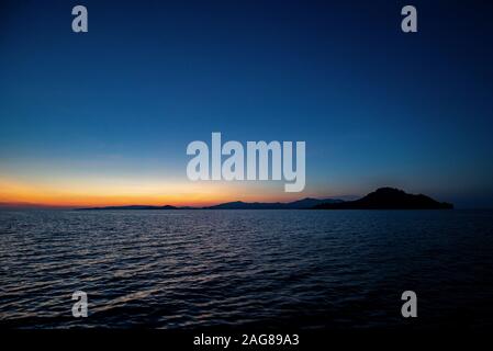 sunset over tropical island raja ampat, Indonesia Stock Photo