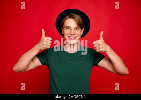 Portrait of positive cheerful imposing guy show thumb up recommend sales discounts give feedback about ads wear casual lifestyle outfit isolated over Stock Photo