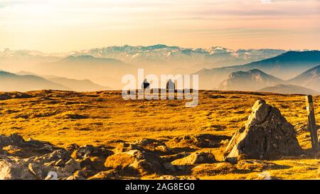 Two people enjoying view of rocky Austrian mountains from Schockl in Styria Graz. Stock Photo