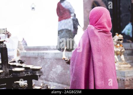 Closeup shot from behind of an elderly person burning sage with a blurred background Stock Photo