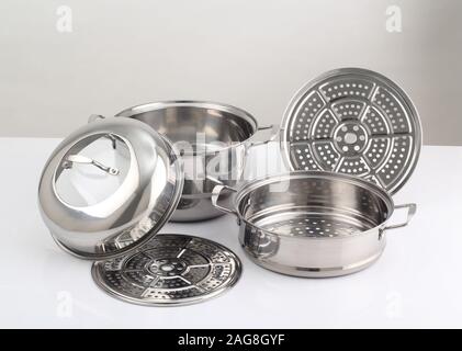 set of stainless steel pots isolated on white background Stock Photo