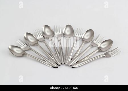 kitchenware set of stainless steel spoons and forks isolated on white background Stock Photo