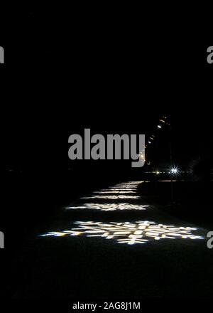 Projected snowflake patterns on the paths as part of the Christmas lights at Blenheim Palace, Woodstock. Stock Photo