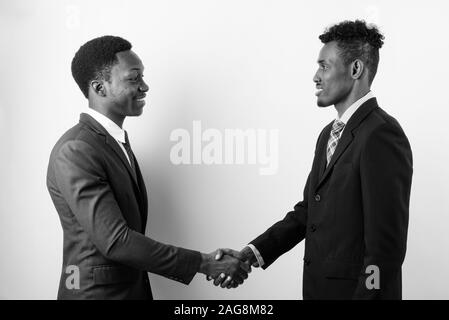 Side profile of two businessmen greeting each other Stock Photo - Alamy