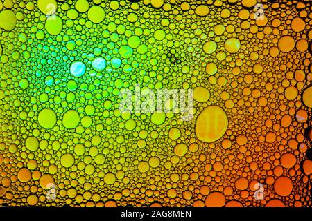 Colorful drops of oil on the water. Circles and ovals. Abstract bright background for design. Stock Photo