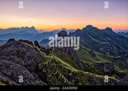 View of mountainous dolomiti landscape around Fedaia Lake, Lago di Fedaia at sunrise, the Setsas mountains in the distance Stock Photo