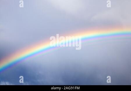 rainbow in the sky against dark cloud,  natural weather background Stock Photo