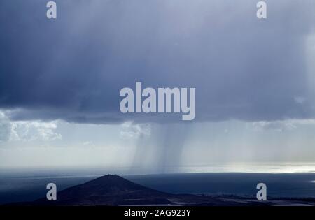 Gran Canaria, December, view from the top of Montana de Aguimes mountain towards Arinaga, falling rain Stock Photo
