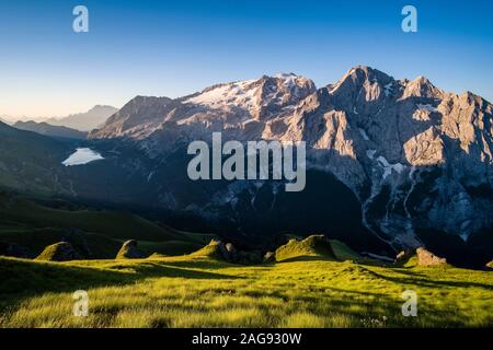 Panoramic view of mountainous dolomiti landscape around Fedaia Lake, Lago di Fedaia, and the summit of Marmolata, Marmolada at sunrise Stock Photo