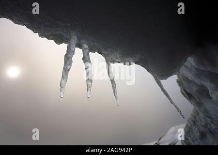 Icicles dripping water from a slowly melting iceberg at Brown Bluff on the Tabarin Peninsula in northern Antarctica. Stock Photo