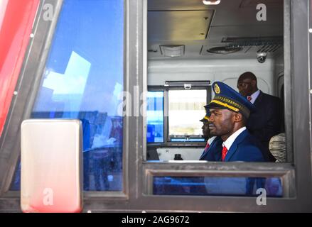 (191218) -- NAIROBI, Dec. 18, 2019 (Xinhua) -- Train conductors make preparation for the launch of the Nairobi-Naivasha Standard Gauge Railway (SGR) cargo service in Nairobi, Kenya, on Dec. 17, 2019. Kenya on Tuesday launched the Nairobi-Naivasha SGR cargo service and an inland container depot (ICD) that are expected to revolutionize transport of bulk cargo to the east Africa nation's hinterland and neighboring countries. (Xinhua/Li Yan) Stock Photo