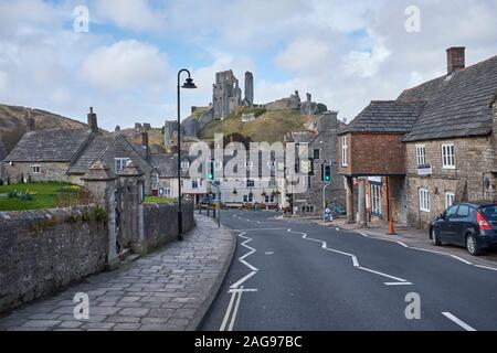 A view of Corfe Castle from a quiet East Street in the village of the same name, Corfe, Dorset, England, UK Stock Photo