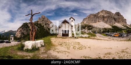 Panoramic view of a small chapel and the summits of Lagazuoi and Sass de Stria at Falzarego Pass, Passo di Falzarego Stock Photo