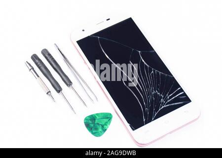 Cell phone with a broken screen on a white background. Repair of a cell phone with a broken screen in the service with a special tool. Cell Phone Repa Stock Photo