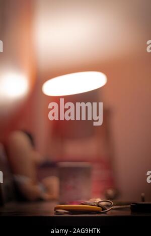 Vertical selective focus shot of keys under the living-room light Stock Photo