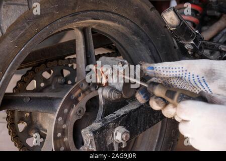 The process of replacing brake pads on a motorcycle. Maintenance motorcycles. Repair and maintenance of motorcycles before the season Stock Photo