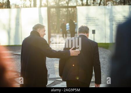 18 December 2019, Berlin: Romani Rose (l-r), Chairman of the Central Council of the German Sinti and Roma, and Jeremy Issacharoff, Ambassador of the State of Israel, walk around the monument to the Sinti and Roma of Europe murdered under National Socialism after a wreath-laying ceremony. Photo: Gregor Fischer/dpa Stock Photo