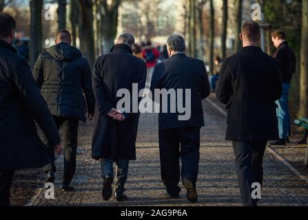 18 December 2019, Berlin: Romani Rose (centre l-r), Chairman of the Central Council of the German Sinti and Roma, and Jeremy Issacharoff, Ambassador of the State of Israel, will go to their vehicles together after a wreath-laying ceremony at the monument to the Sinti and Roma of Europe murdered under National Socialism. Photo: Gregor Fischer/dpa Stock Photo
