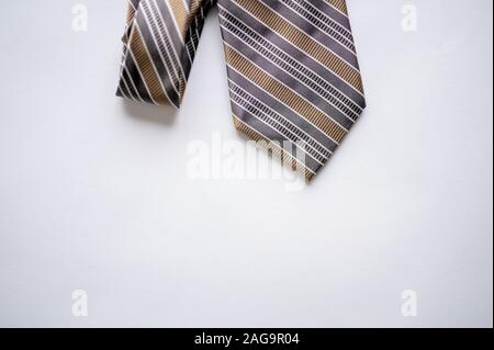 Overhead  shot of a striped tie on a white surface Stock Photo