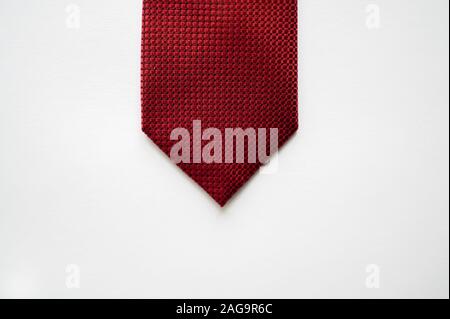 Overhead shot of a red tie on a white surface Stock Photo