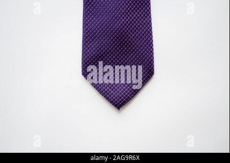 Overhead shot of a purple tie on a white surface Stock Photo
