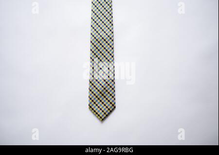 Overhead shot of a striped tie on a white surface Stock Photo