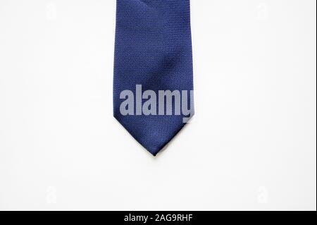 Overhead shot of a blue tie on a white surface Stock Photo