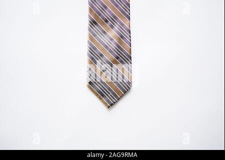 Overhead shot of a striped tie on a white surface Stock Photo