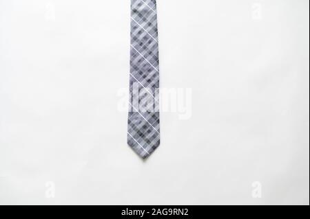Overhead shot of a striped tie on a white surface Stock Photo