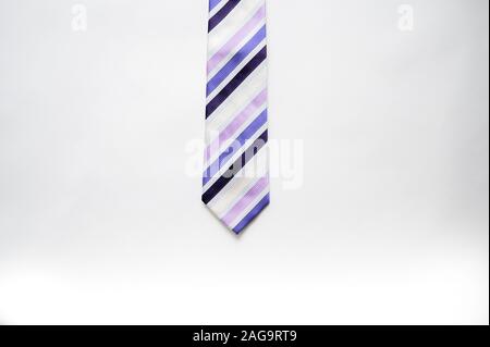 Overhead shot of a striped tie on a white surface Stock Photo