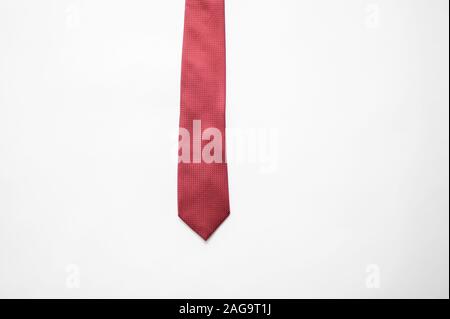 Overhead shot of a red tie on a white surface Stock Photo