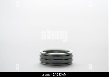Closeup shot of a silver ring on a white surface Stock Photo