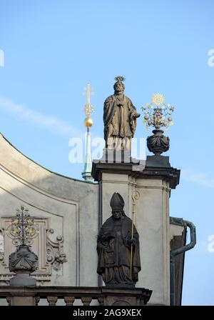 Old medieval sandstone sculptures of apostle and church father by Johann Georg Bendl on facade of St. Salvator Church in Old Town of Prague, Czech Rep