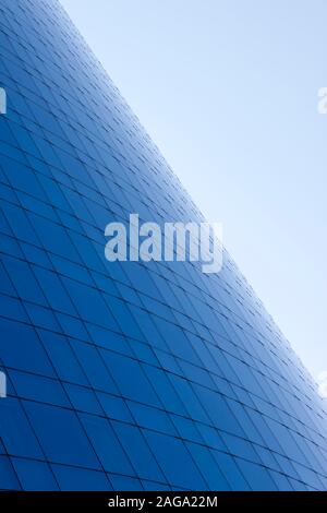 Blue glass windows business building facade and sky background. Stock Photo