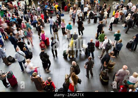 KINGS CROSS, LONDON, UK - JULY 21, 2016.  Looking down from above onto crowds of rail commuters and passengers patiently waiting for their trains at a