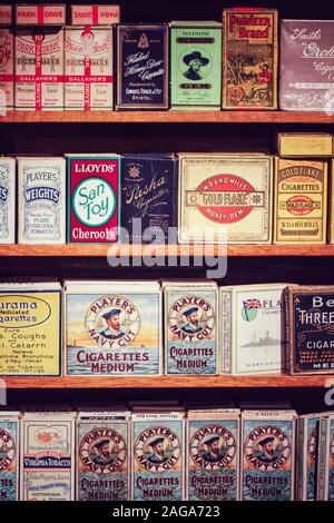 CORNWALL, UK - JUN 28, 2016.  A Tobacconist shelves stacked with packets and tins of old cigarettes, tobacco and cigars such as Players Navy Cut Stock Photo