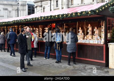 London, UK. 18th Dec, 2019. People enjoying Trafalgar Square Christmas market on a clear but cold day one week before Christmas. Credit: JOHNNY ARMSTEAD/Alamy Live News