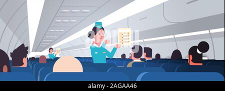 stewardess explaining for passengers instructions card female flight attendants safety demonstration concept modern airplane board interior horizontal portrait vector illustration Stock Vector