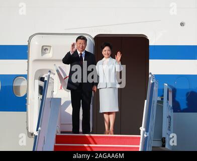 (191218) -- MACAO, Dec. 18, 2019 (Xinhua) -- Chinese President Xi Jinping, also general secretary of the Communist Party of China Central Committee and chairman of the Central Military Commission, and his wife Peng Liyuan step out of the hatch and greet the welcoming crowd after landing at Macao International Airport in Macao, south China, Dec. 18, 2019. The president is expected to attend a gathering celebrating the 20th anniversary of Macao's return and the inauguration ceremony of the fifth-term government of the Macao Special Administrative Region (SAR) on Friday. He will also inspect the Stock Photo